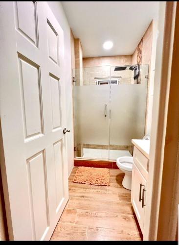 La salle de bains est pourvue d'une douche, de toilettes et d'une porte. dans l'établissement Grey Stone Villa, à Happy Hill