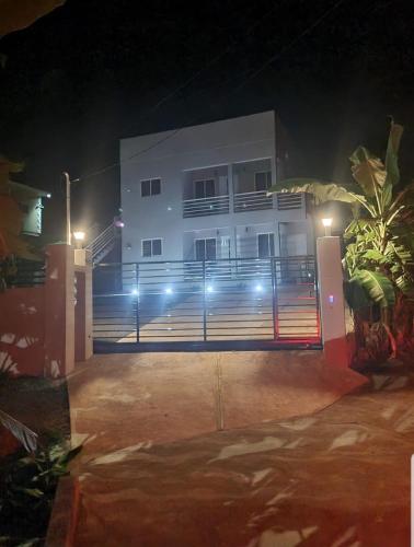 a white building with lights in front of it at night at Grey Stone Villa in Happy Hill