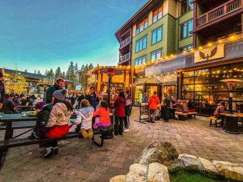 a group of people sitting on a bench in a market at Gondola Chalet -New Luxury 5 Bdrm Condo @ Canyon Lodge, Steam Room in Mammoth Lakes