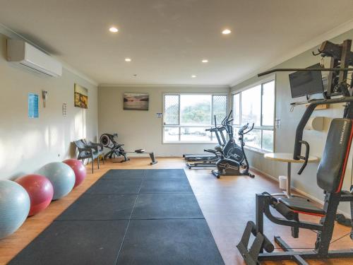 een fitnessruimte met loopbanden en fitnessapparatuur in een kamer bij NRMA Port Campbell Holiday Park in Port Campbell