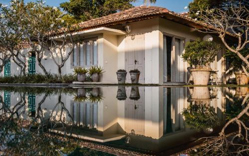 a house with its reflection in the water at Elysium in Unawatuna