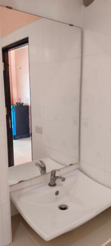 a bathroom with a mirror and a sink at Moon Travel Phangan in Ban Nua