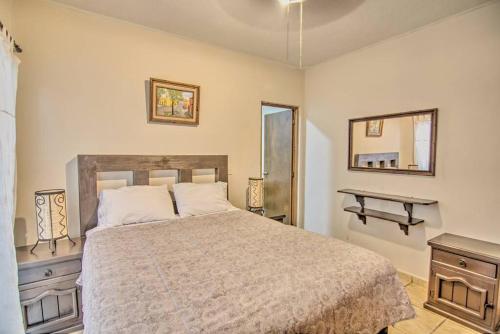 a bedroom with a bed and a table and a mirror at Perla del Mar - Large Pool and 6 blocks to Beach in Bucerías