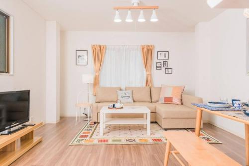 a living room with a couch and a table at Osaka Viewing House丨4min-st aion丨Near Namba, Umeda liubj4 in Osaka
