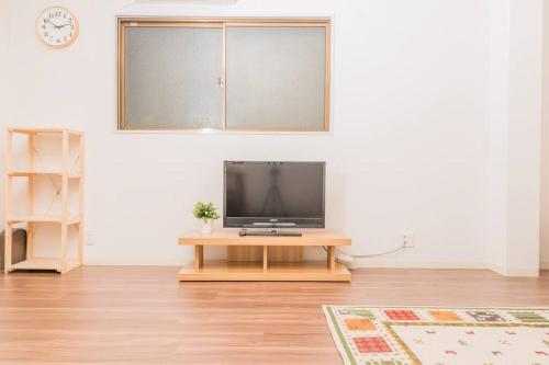 a living room with a television on a table at Osaka Viewing House丨4min-st aion丨Near Namba, Umeda liubj4 in Osaka
