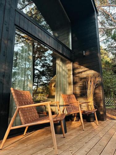 two chairs and a bench on a wooden deck at Bird nest in Undva