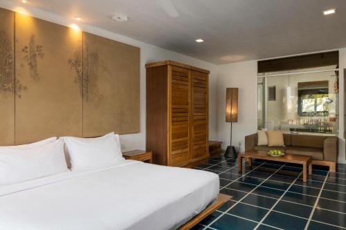 a bedroom with a bed and a living room at Jetwing Blue in Negombo