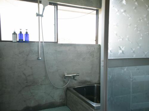 a bathroom with a shower with a tub and a sink at 范冰冰 ファン・ビンビン in Shimo-ōzu