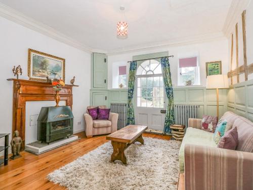 a living room with a couch and a fireplace at Southrepps Lodge in Norwich