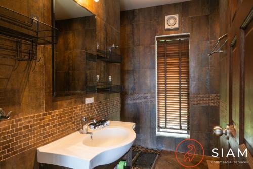 a bathroom with a sink and a mirror at Chaweng Hill Apartment 2Br & Private Pool in Koh Samui 