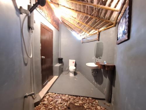 a small bathroom with a toilet and a sink at Miss You Beach Resort Koh Mak in Ko Mak
