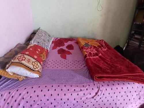 a bed with two pillows on top of it at Bursol Homestay by StayApart in Chamoli