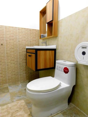 a bathroom with a toilet and a sink at Swiss Bonihouse Koh Yao Yai in Ban Pru Nai