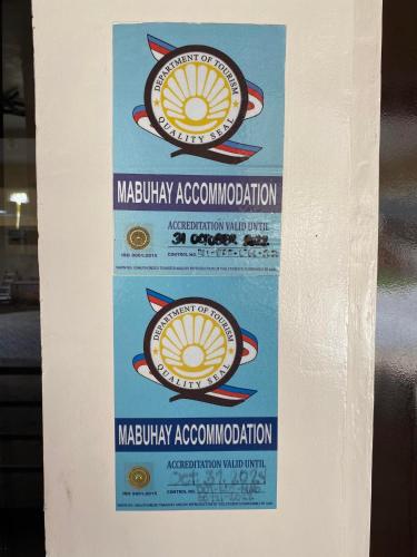 a sign for a miami association on a wall at Casa Marie Hotel in Daet