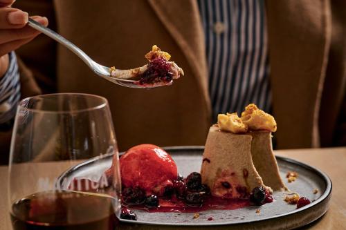 a person holding a piece of dessert on a fork at Rydges Geelong in Geelong