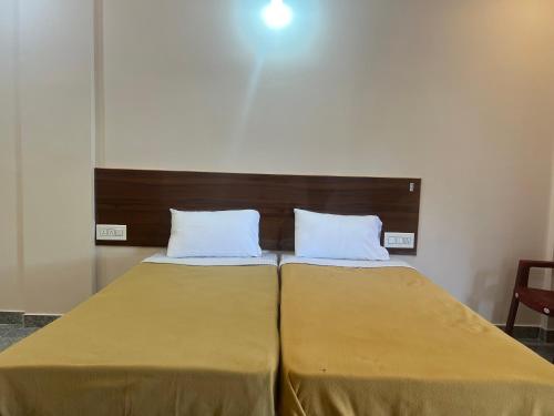 two beds sitting next to each other in a room at Rt Service Apartments Hotel in Velankanni