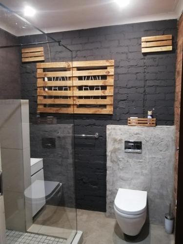 a bathroom with a toilet and a glass shower at Budget Room in Pietermaritzburg