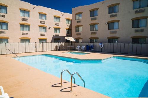 a large swimming pool in front of a hotel at Super 8 by Wyndham Yuma in Yuma