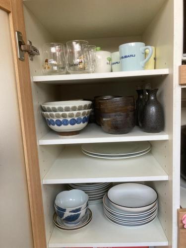 a cupboard filled with plates and bowls and dishes at 3-min to Station,5BR, 1LR villa near Asakusa, 95平米5间卧室休息好 Stay Dream Hotel in Tokyo
