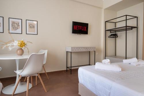 a bedroom with a bed and a table and a desk at ATHENS STORIES in Athens
