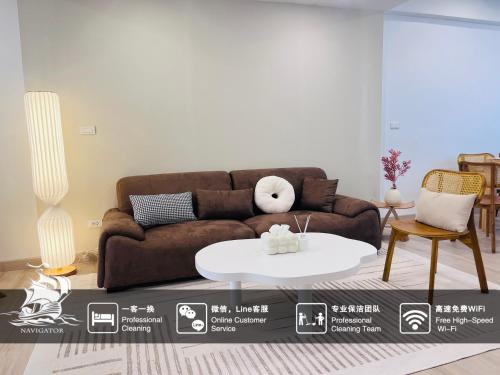 a living room with a brown couch and a white table at BKK Villa/Huaikwang China Twon in Bangkok