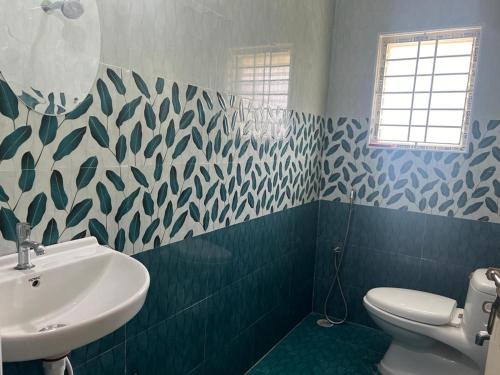 a bathroom with a sink and a toilet at RT Service Apartment Villas in Velankanni