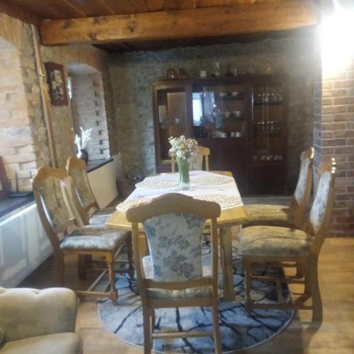 a dining room with a table and chairs at Chalupa u Brčáků in Ktiš