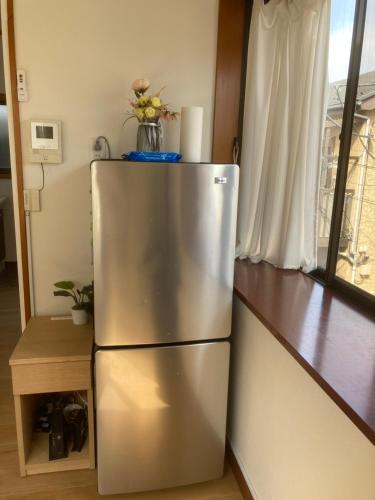 a stainless steel refrigerator in a kitchen with a window at 3-min to Station,5BR, 1LR villa near Asakusa, 95平米5间卧室休息好 Stay Dream Hotel in Tokyo