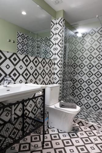 a bathroom with a sink and a toilet and a tub at ATHENS STORIES in Athens