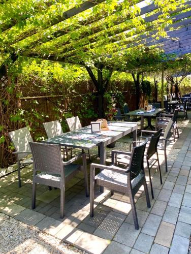 a table and chairs sitting under a pergola at Old Tree Village & Restaurant in Oświęcim