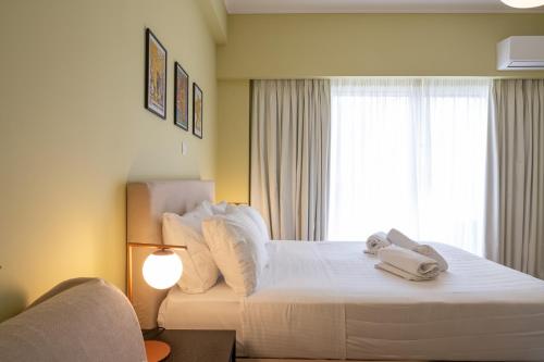 a hotel room with a bed with towels on it at ATHENS STORIES in Athens