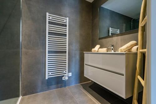 a bathroom with a sink and a mirror at La Bohème in Liège