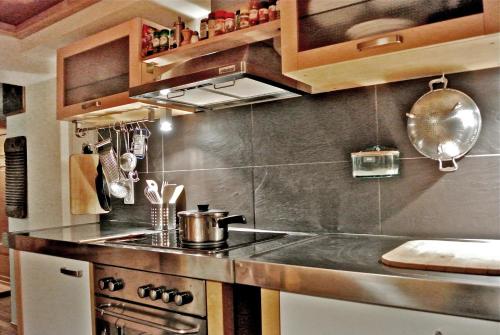 a kitchen with a sink and a stove at Grosshus Vals in Vals