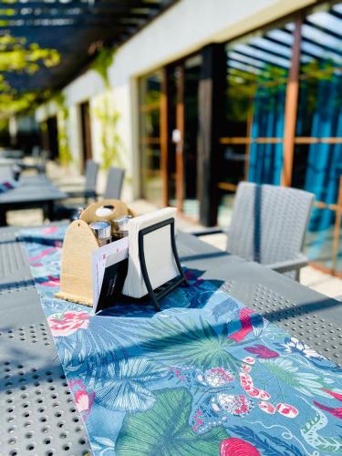 a table with a table cloth with a laptop on it at Old Tree Villa & Restaurant in Oświęcim