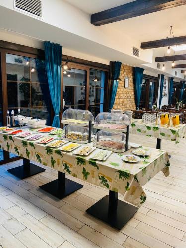 a table with plates of food on top of it at Old Tree Villa & Restaurant in Oświęcim