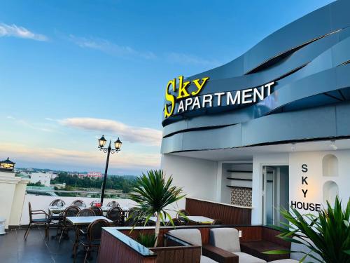 a restaurant with tables and chairs on a roof at Sky House Apartment in Tam Ky