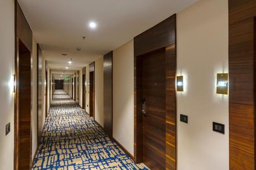 a hallway of a hotel with a carpeted corridor at Cygnett Inn Imperial Tezpur in Tezpur