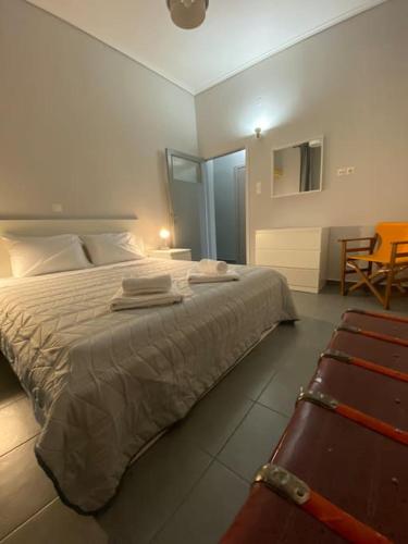 a bedroom with a large bed with towels on it at Elia's boutique apartment in Sparta