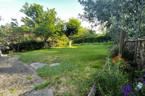 un patio con una valla y algunas flores en L'Oustal de l'Olivier, en Rignac