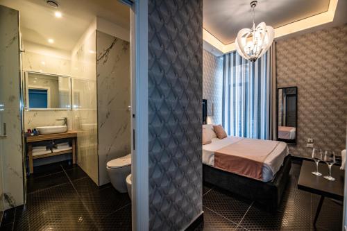 Un dormitorio con una cama y un baño con lavabo. en Sole Luxury Bed and Breakfast, en Nápoles