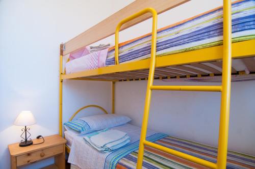 a bunk bed with yellow bunk beds in a room at Villa Bruffalori in Sampieri