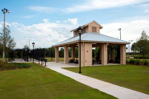 a gazebo in a park with benches at TownePlace Suites Orlando at FLAMINGO CROSSINGS® Town Center/Western Entrance in Orlando