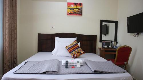 a bed with two towels and a pillow on it at Crystal Premier Hotel in Pantang