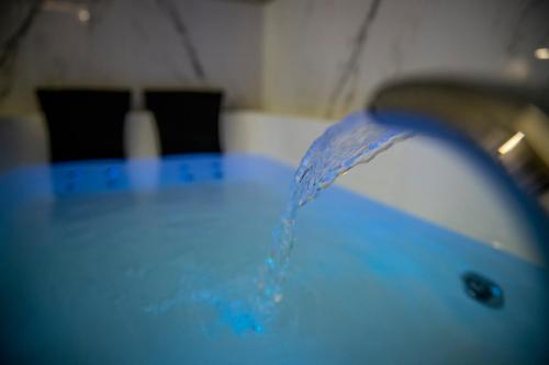 a blue table with water coming out of it at Luna Luxury Bed and Breakfast in Naples