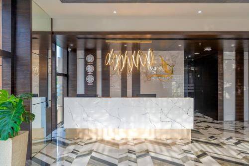 a lobby with a marble counter in a building at Cygnett Inn Imperial Tezpur in Tezpur