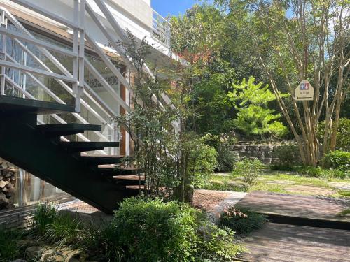 a staircase leading up to a building with a sign at Lin Qi in my heart Villa in Dongshi