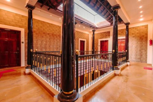 a large hallway with columns and a balcony at Shell Park in Kanyakumari