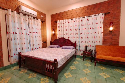 a bedroom with a bed and a window with curtains at Shell Park in Kanyakumari