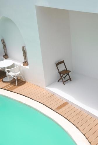 a room with a table and a chair next to a swimming pool at Bassa nova villa in Panglao