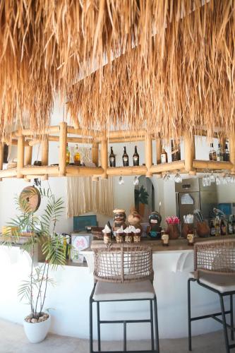 a kitchen with two chairs and a counter with a table at Bassa nova villa in Panglao